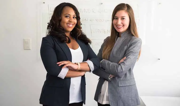 Two people dressed in professional clothing.
