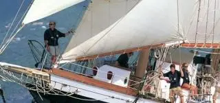 ITA teacher sitting on the floor with her students