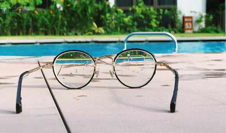 Glasses against poolside view