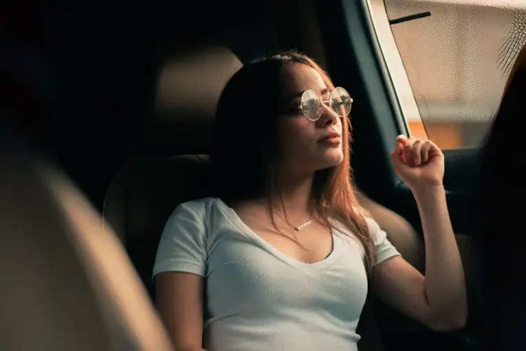 woman looking out a car window