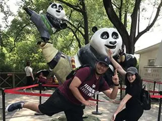 USAC students taking a photo with the Kung Fu Panda manikins.