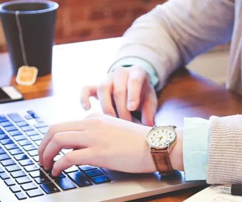 woman typing in a laptop
