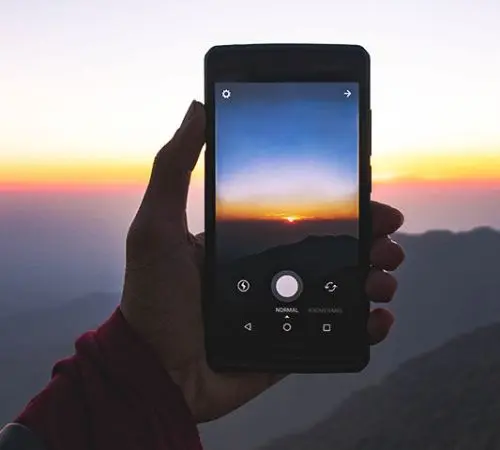 Picture of cellphone capturing sunset view