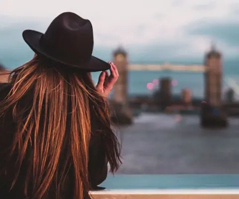 Woman looking at Tower Bridge from a distance