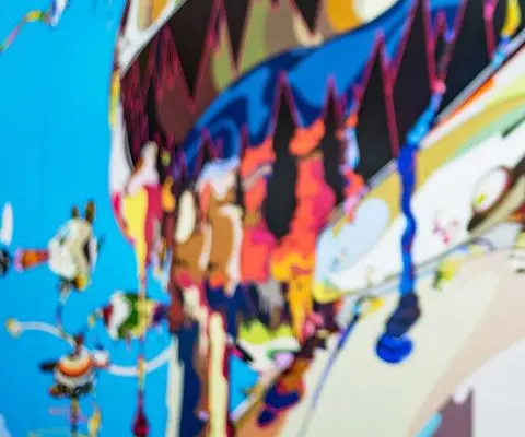 Two girls hugging by a mural