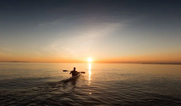man in a boat at sunset
