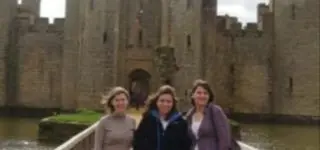 ITA teacher sitting on the floor with her students