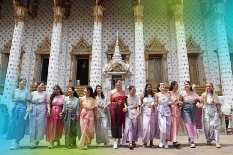 Interns embracing Thai culture by wearing traditional Thai clothing.