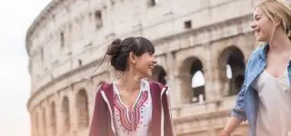 ITA teacher sitting on the floor with her students