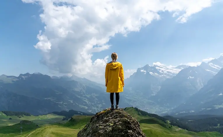 person standing on a rock in switzerland