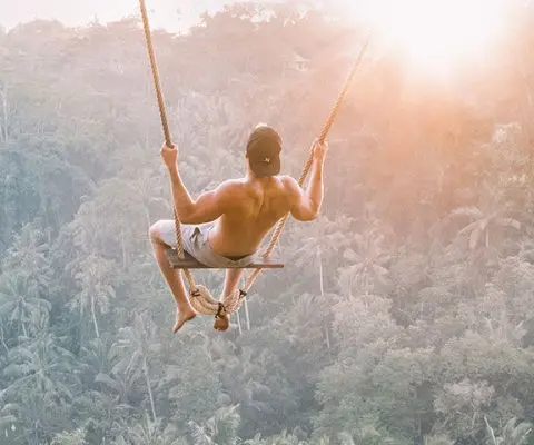 man on swing in Indonesia