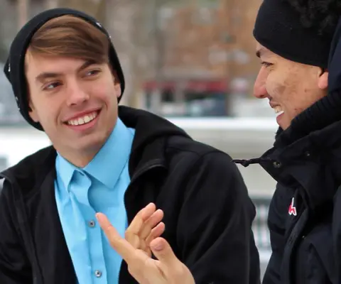 two men chatting outside