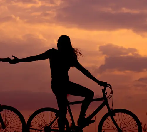 couple biking at sunset