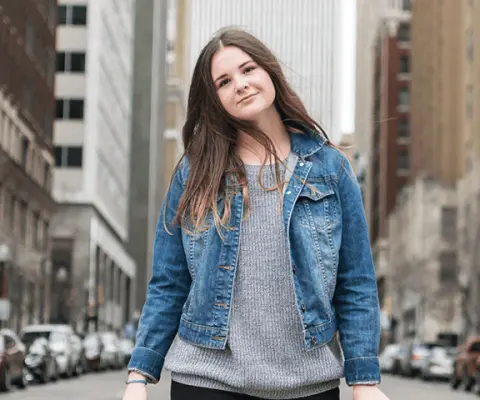 girl posing with graduation cap in the street