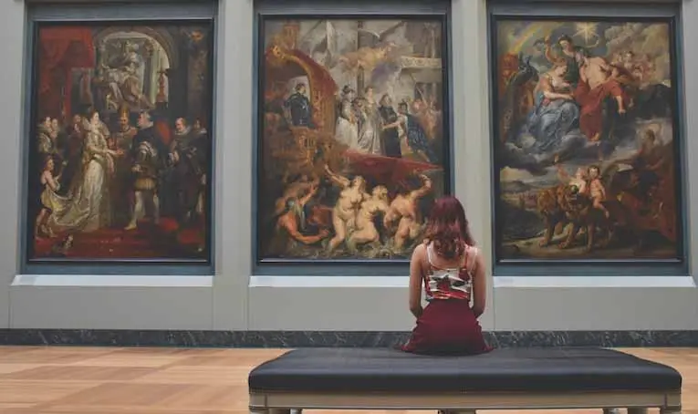study abroad student admiring artwork in a museum.