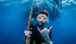 Scuba diver making hang loose sign.
