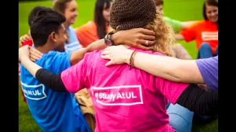 Students arms linked and T-Shirt reads  #study at UL 