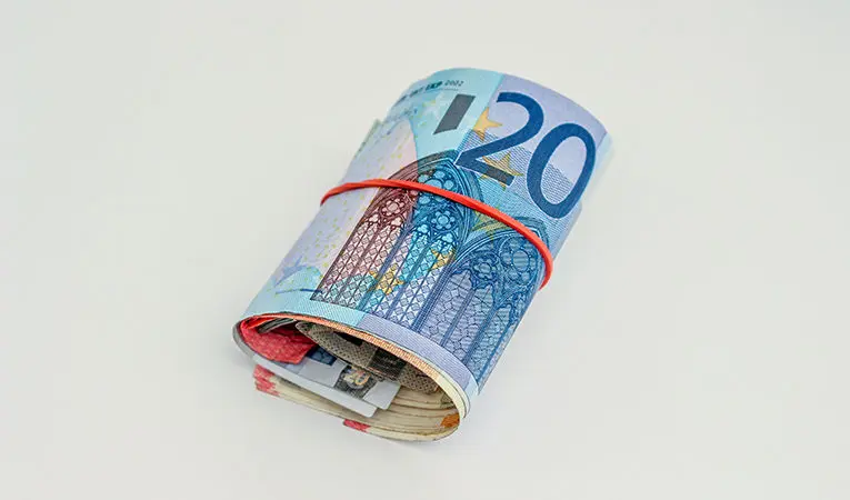 Roll of Euro banknotes on white background