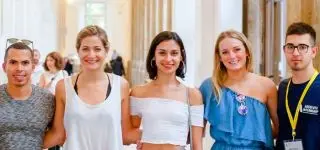 ITA teacher sitting on the floor with her students