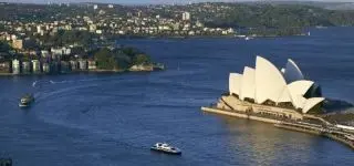 ITA teacher sitting on the floor with her students