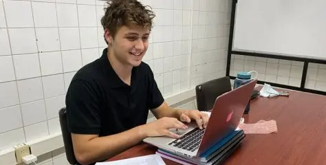 online intern doing work on his laptop